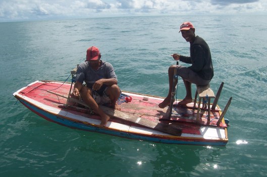 Neu (far right)on his friends boat, Neu's presence didn't improve his friends catch rate