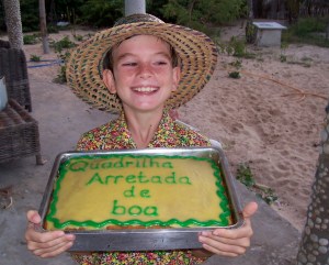 My son with the cake we made for the Junina festival