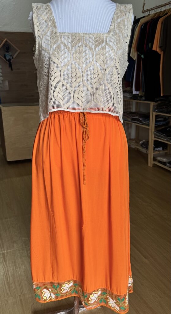 A cropped top made of labirinto and an orange skirt with labirinto boarder at the hem