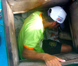 Homem descendo para o pequeno espaço dentro de uma jagada tradicional.