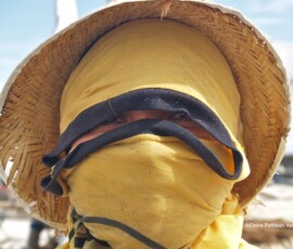 Using a T-shirt to protect from the sun while fishing man using a t shirt wrapped around his head and face to protect from the sun while fishing