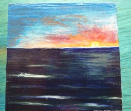 Caixa pintada à mão com um nascer do sol sobre o mar.